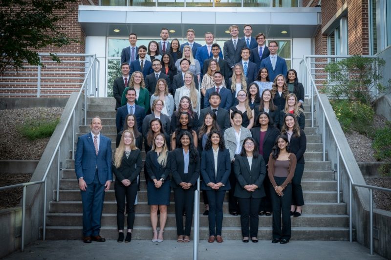 A group photo of members of the VTCSOM Class of 2026 along with Dean Learman on the steps of the VTCSOM building.
