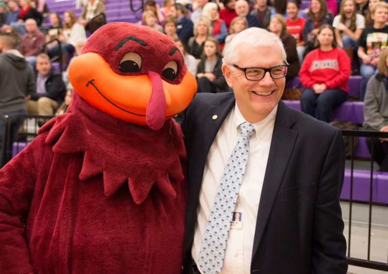 Dan Harrington smiles alongside the Hokie Bird.