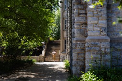 A student climbs the steps outside Campbell Hall. 