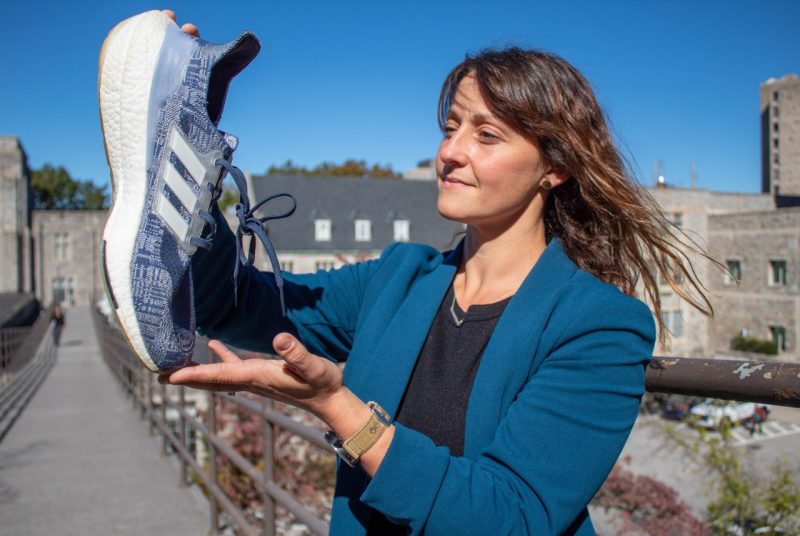 A person holds an athletic shoe.