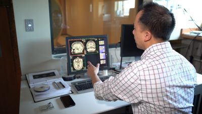 A Virginia Tech researcher shows what the MRI brain scans look like while a participant is scanned.