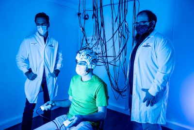 Two researchers and a volunteer are inside the Fralin Biomedical Research Institute's new optically pumped magnetometry laboratory